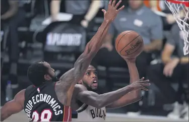  ?? MARK J. TERRILL - THE ASSOCIATED PRESS ?? Bucks’ Khris Middleton shoots past Heat’s Andre Iguodala, Sept. 6, in Lake Buena Vista, Fla.