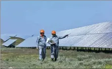  ?? XINHUA ?? Workers monitor solar panels at a solar power plant jointly built by China and Kazakhstan in the town of Kapchagay, in southeaste­rn Kazakhstan’s Almaty Region.