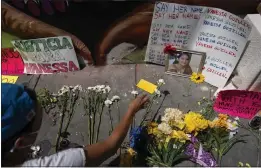  ?? CAROLYN KASTER — THE ASSOCIATED PRESS FILE ?? Frida Larios places flowers near of photograph of slain Army Spc. Vanessa Guillen at the base of a mural of Guillen on 14th Street NW in Washington. Guillen was killed by a soldier, who her family says sexually harassed her, and who killed himself as police sought to arrest him.