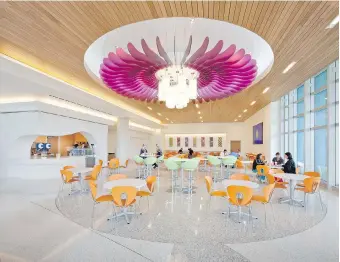  ??  ?? A flower blooms overhead in the dining area at Nemours children’s hospital in Orlando, with a design theme centred on creating a hospital in a garden.