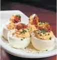  ??  ?? Deviled eggs are a highlight. Horseradis­h and a fried nugget of chicken liver top each yolk.