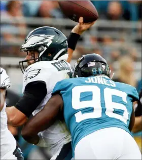  ?? STEPHEN B. MORTON — THE ASSOCIATED PRESS ?? Jaguars defensive end Datone Jones (96) hits Eagles quarterbac­k Cody Kessler, left, as he tries to throws a pass during the first half.