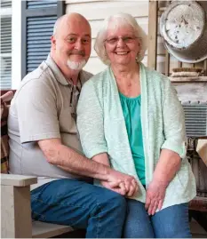  ?? ?? Larry and Nina reflect on their happy retirement in Kentucky on their new side porch. Nina’s laundry-themed outdoor display, composed of a washbasin and washboard hung on a trellis, lends charm to the setting. “I really love the look of weathered metal,” she says.