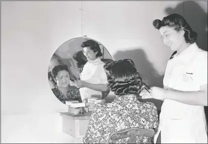  ?? (File Photo/AP) ?? Mary Takita of Walnut Grove, Calif., works in May 1943 on the hair of Mrs. Y. Yoshihara of Olympia at the Japanese relocation camp in Tule Lake, Calif.