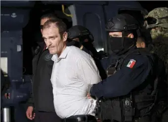  ?? MEXICO’S ATTORNEY GENERAL’S OFFICE VIA AP ?? In this June 15, 2016 file photo provided by the Mexican Attorney General’s Office, Hector “El Guero” Palma, or “Blondie,” one of the founders of the Sinaloa Cartel, is escorted in handcuffs from a helicopter at a federal hangar in Mexico City, after serving almost a decade in a U.S. prison and transporte­d to another maximum-security lockup to await trial for two murders.