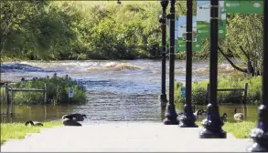  ?? Patrick Sikes / For Hearst Connecticu­t Media ?? The Rippowam River floods into Mill River Park in Stamford the morning after Ida hit the area.