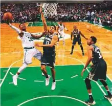  ?? AFP ?? ■ Marcus Smart (36) of the Boston Celtics takes a shot against Malcolm Brogdon (13) of the Milwaukee Bucks in game seven of round one of the play-offs.