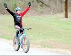  ?? Keith Bryant/The Weekly Vista ?? Matt Ernst, who came from Kansas City for the Back 40 Trail run and ride, finishes the 20-mile ride. He and a group of friends from Kansas City all rode fat bikes, and he was the second fat bike rider to finish the loop. "Pure ignorance," he said of...