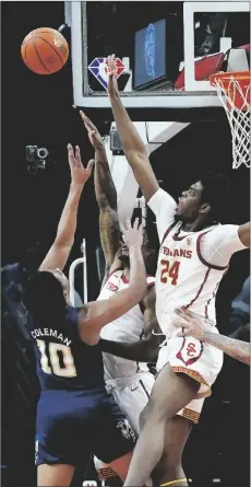  ?? AP PHOTO/ROSS D. FRANKLIN ?? Georgia Tech guard Dallan Coleman (10) tries to get off a shot over Southern California forward Joshua Morgan (24) and guard Isaiah White during the first half of an NCAA college basketball game at the Jerry Colangelo Classic on Saturday in Phoenix.