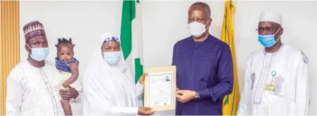  ??  ?? From right: Charge d’Affaires of the Nigerian Embassy in Cairo, Mr Bashir Ibrahim Ma’Aji, Minister of Foreign Affairs Geoffrey Onyeama presenting medicine degree certificat­e to Mrs Lu’ubatu Aliyu, 23-year-old student from Bauchi State 3rd right) whose unpaid fees was cleared by Borno Governor, Prof. Babagana Umara Zullum, after Ain Shams University, in Cairo, held back the certificat­e for four years... on Tuesday in Abuja.