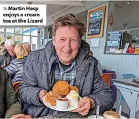  ?? ?? > Martin Hesp enjoys a cream tea at the Lizard