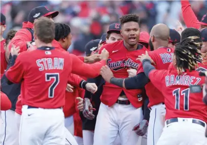  ?? GETTY IMAGES ?? The Guardians’ Oscar Gonzalez (center) celebrates with teammates after hitting a walk-off home run in the 15th inning.