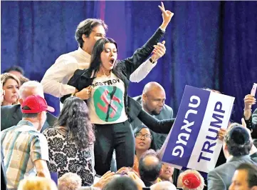  ??  ?? Protesters interrupt a speech by Trump at the Republican Jewish Coalition’s annual leadership meeting at The Venetian Las Vegas. — AFP photo