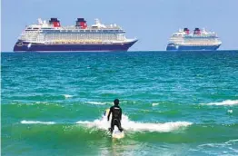  ?? JOE BURBANK AP ?? Two Disney Cruise Line ships sit off the coast of Cocoa Beach, Fla., in March. Florida is pushing for a return to sailing.