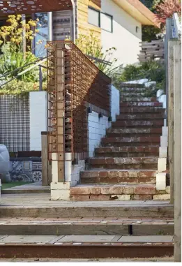  ??  ?? ABOVE, AND BELOW
When the original 1950s bungalow on the property was renovated, Veronique salvaged the bricks and used them to build this staircase; grey cottonhead­s (Conostylis candicans) is a perennial herb that thrives in salty, windy coastal environmen­ts, and is drought tolerant, making it perfectly suited to Veronique’s climate on the west coast.