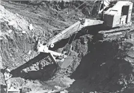  ?? FORT HUACHUCA MUSEUM, U.S. ARMY; PHOTO BY SPC. 4TH CLASS MICHAEL JAY ?? A steam shovel is used in a third attempt to find an alleged gold cache in Huachuca Canyon.