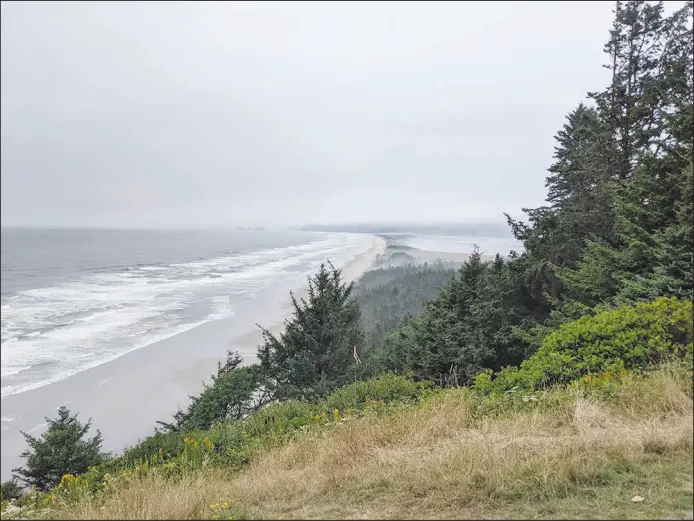  ?? NICHOLAS SCAGLIONE VIA THE NEW YORK TIMES ?? Cape Lookout State Park, Ore., along the Three Capes Scenic Loop, offers a view over the sandspit that divides Netarts Bay from the Pacific Ocean. The Three Capes area offers a quieter version of the classic road trip, with rugged scenery and hidden beaches off the main highway.