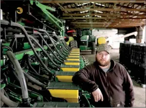  ?? Minneapoli­s Star Tribune/ANTHONY SOUFFLE ?? Claremont, Minn., farmer Mike Petefish stands next to a planter in his equipment shed in early April.