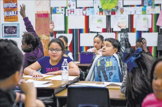  ?? Patrick Connolly Las Vegas Review-Journal @PConnPie ?? Ricardo Martinez, center right, raises his hand with Yaritzel Rios-Perez next to him in a fourth-grade class at H. P. Fitzgerald Elementary School in North Las Vegas.