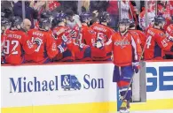  ?? NICK WASS/ ASSOCIATED PRESS ?? Washington’s Alex Ovechkin accepts congratula­tions from teammates on the bench after ending his 10-game scoring drought.