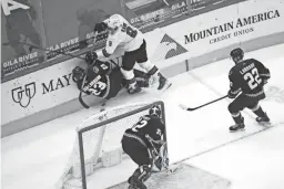  ?? PATRICK BREEN/THE REPUBLIC ?? The Sharks’ Evander Kane (9) hits the Coyotes’ Oliver Ekman-Larsson (23). The Coyotes captain will miss the trip to Las Vegas.