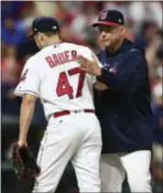  ?? DAVID DERMER — THE ASSOCIATED PRESS ?? Cleveland manager Terry Francona congratula­tes starting pitcher Trevor Bauer as Bauer leaves during the seventh inning Thursday in Cleveland. Bauer pitched 6 2⁄3 innings and gave up two hits.