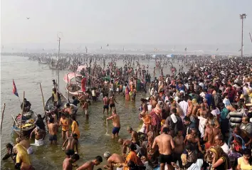  ?? — PTI ?? Devotees take a holy dip at the Sangam on the occasion of Basant Panchami during Magh Mela in Allahabad on Monday.