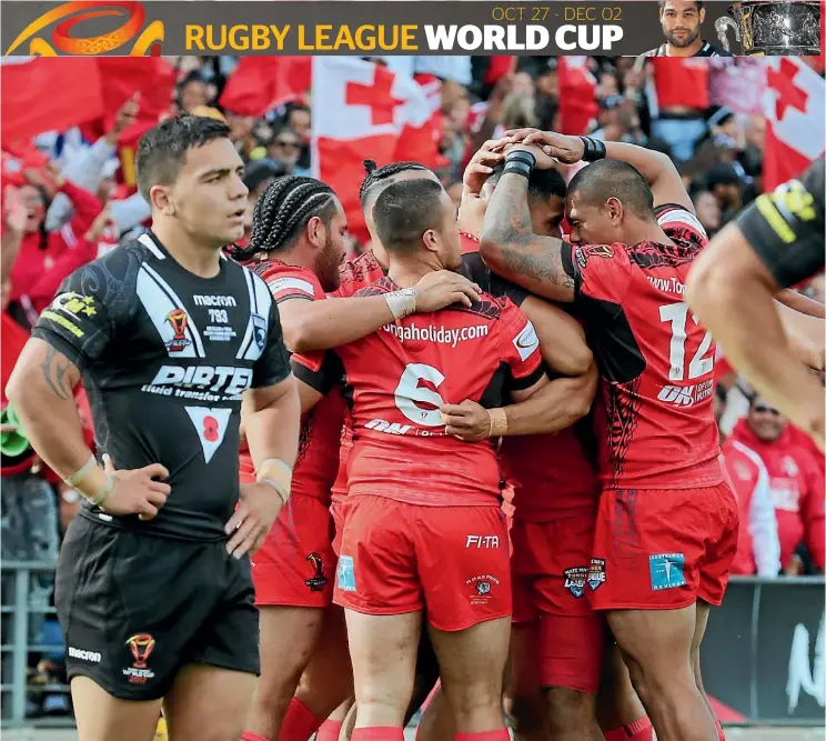  ??  ?? Kodi Nikorima looks on in disbelief as Tonga celebrate another try during their famous win over the Kiwis in Hamilton yesterday.