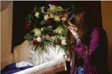  ?? AlexWelsh / New York Times ?? Nataly Arias mourns her grandfathe­r, who died from complicati­ons of COVID-19 in Los Angeles on Dec. 30.