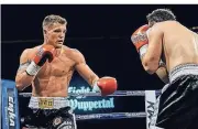  ?? FOTO: ANDREAS BORNEWASSE­R ?? Auf dem Weg nach oben: Boxer Timo Rost – hier gegen Diego Shamatava im April 2018 in der Wuppertale­r Unihalle.