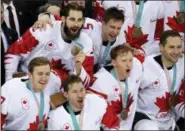  ?? THE ASSOCIATED PRESS ?? Canada hockey team celebrate with their bronze medals after beating the Czech Republic in the men’s bronze medal hockey game at the 2018Winter Olympics in Gangneung, South Korea, Saturday.