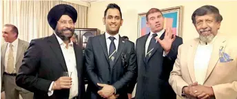  ??  ?? Skandakuma­r (R) at a social event with Indian cricketer MS Dhoni (2nd L)