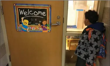  ?? Courtesy of Jackie Spinner ?? The author’s 6-year-old son waits to enter his kindergart­en classroom in Chicago.