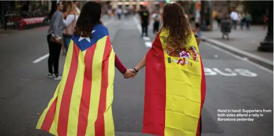  ??  ?? Hand in hand: Supporters from both sides attend a rally in Barcelona yesterday