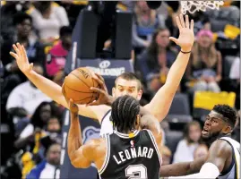  ?? Associated Press photo ?? San Antonio Spurs forward Kawhi Leonard controls the ball against Memphis Grizzlies center Marc Gasol, left, and forward James Ennis during the first half of Game 4 in an NBA basketball first-round playoff series Saturday in Memphis, Tenn.