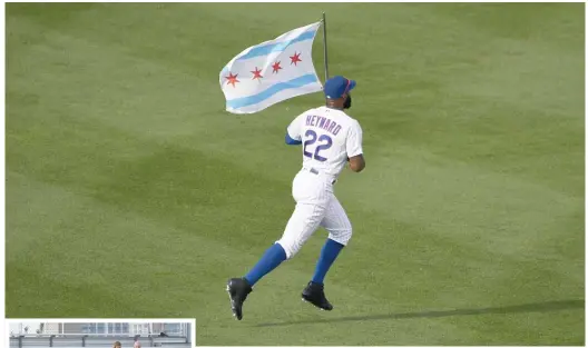  ?? DAVID BANKS/AP ?? In a symbolic moment, Cubs right fielder Jason Heyward takes the field carrying the flag of Chicago.