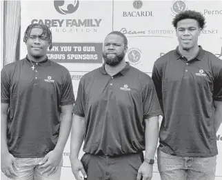  ?? DAVID FURONES/SUN SENTINEL ?? Former Hurricanes and Dolphins offensive lineman Vernon Carey Sr., center, with sons Vernon Carey Jr., right, and Jaylen Carey at the Carey Family Foundation’s 11th annual golf tournament.