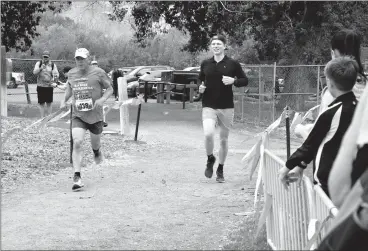  ?? HERALD PHOTO BY JUSTIN SEWARD ?? Carl Dueck runs to the finish line with nephew Jaden Hamm by his side during the Cactus Coulee Crawl over the weekend in the city’s river valley.