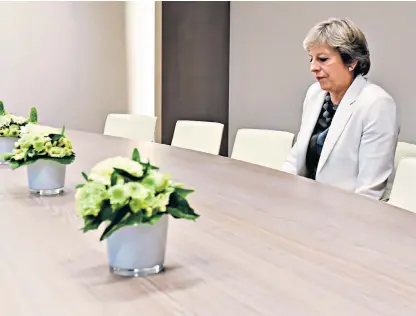  ??  ?? Cards on the table: Theresa May, cutting a lonely figure at the European Council in Brussels yesterday, as the Brexit stakes are raised