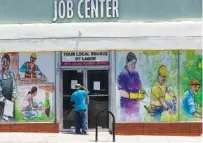  ?? AP FILE PHOTO/DAMIAN DOVARGANES ?? A person looks inside the closed doors of the Pasadena Community Job Center in Pasadena, Calif., last year. An estimated 18 million Americans are collecting some type of jobless aid.