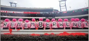  ?? AP/JOHN BAZEMORE ?? Georgia students observe a moment of silence in honor of Wendy Anderson, the wife of Arkansas State Coach Blake Anderson, before the game between the Bulldogs and Red Wolves on Saturday at Athens, Ga. Wendy Anderson died in August after a battle with breast cancer. See more photos at arkansason­line.com/915pinkout.