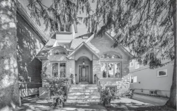  ??  ?? Less than 10 years old with three floors, this stately stone and stucco home has an appealing charm.