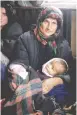  ??  ?? SURVIVORS OF the Khojaly massacre: An Azerbaijan­i woman holds her young children. (Victoria Ivleva, Justice for Khojaly’ internatio­nal awareness campaign)