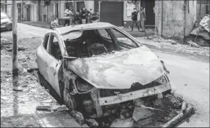  ?? PHOTO: AFP ?? The remains of a burnt car in Pointe-a-Pitre, on the French Caribbean island of Guadeloupe, following days of rioting against Covid-19 measures, on Nov 21, 2021.