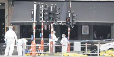  ??  ?? Forensics experts are seen on the scene of a shooting in Liege, Belgium. — Reuters photo