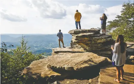  ?? STAFF PHOTO BY DOUG STRICKLAND ?? From left, Brandon Sharp, Tim Sharp, Marshana Sharp and Cara Kosky check out the view of Lookout Valley from an observatio­n point at Point Park on Lookout Mountain while attending the Friends of Chickamaug­a and Chattanoog­a National Military Park...