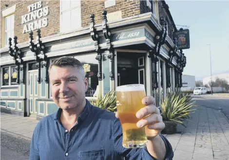  ??  ?? The Kings Arms. Landlord Stefan Emerson with a pint of their best. Left,, staff member Tara Kingston.