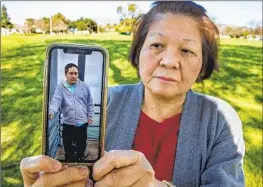  ?? ?? MARY CABANETE shows a photo of son Jude, 31, an Elwyn-Mayall resident. She and Topete allege that a caregiver there “assaulted and battered” their sons.