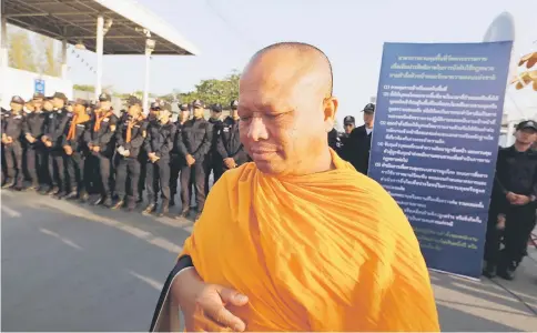  ?? — Reuters photo ?? Thai police block Buddhist monks at the gate of Dhammakaya temple in Pathum Thani province, north of Thailand.