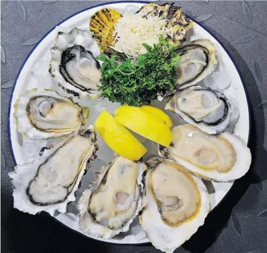  ?? LES BAZSO/ PNG STAFF PHOTO ?? Oyster Express offers up an oyster variety platter of Shigoku, Totten virgins, naked roy and Royal Miyagi at the Chinatown restaurant in Vancouver. The recession has reposition­ed high- end chefs and restaurant­s. Skilled chefs are now serving up...